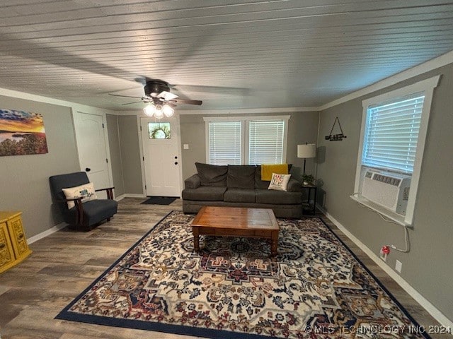 living room with wood-type flooring, cooling unit, ornamental molding, and ceiling fan