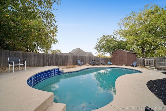 view of pool featuring a storage unit and a patio area