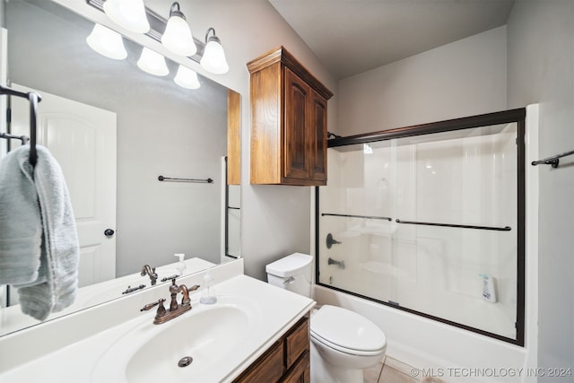 full bathroom with tile patterned floors, vanity, enclosed tub / shower combo, and toilet