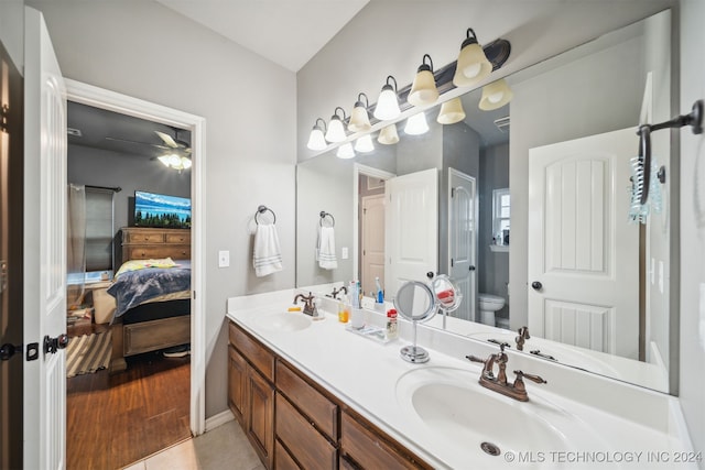 bathroom with vanity, toilet, and hardwood / wood-style flooring