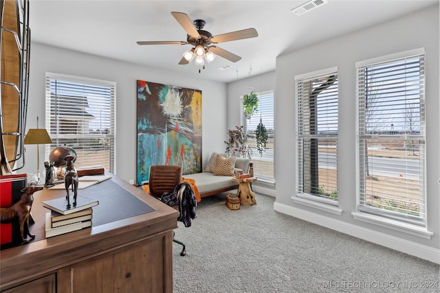 carpeted office space with ceiling fan and a wealth of natural light