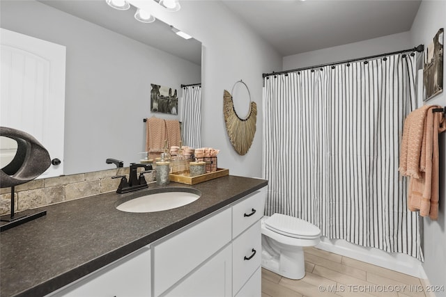 full bathroom with toilet, shower / bath combo with shower curtain, vanity, and wood-type flooring