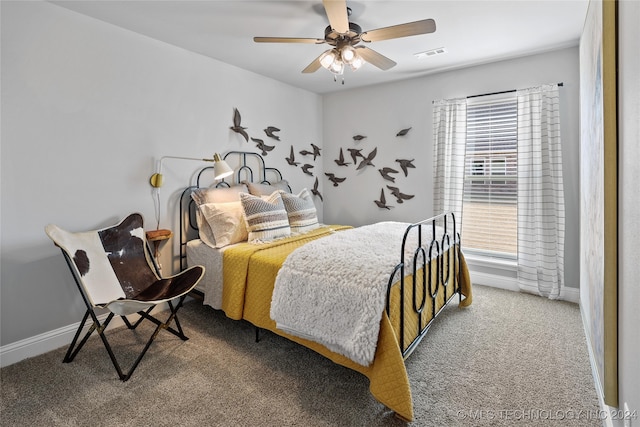 bedroom featuring multiple windows, ceiling fan, and carpet floors