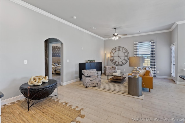 living room featuring ornamental molding, light hardwood / wood-style flooring, and ceiling fan