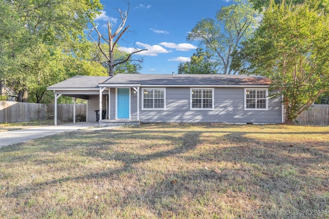 single story home with a front yard and a carport