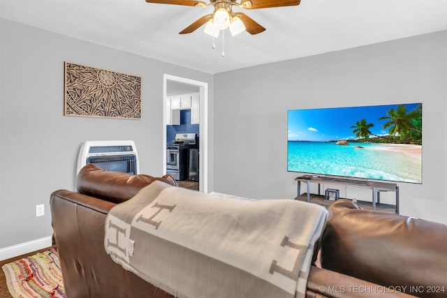 living room with ceiling fan, hardwood / wood-style floors, and heating unit