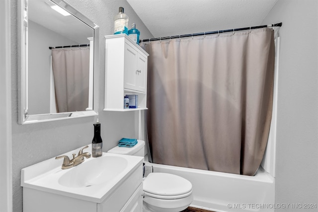 full bathroom featuring vanity, shower / tub combo with curtain, toilet, and a textured ceiling