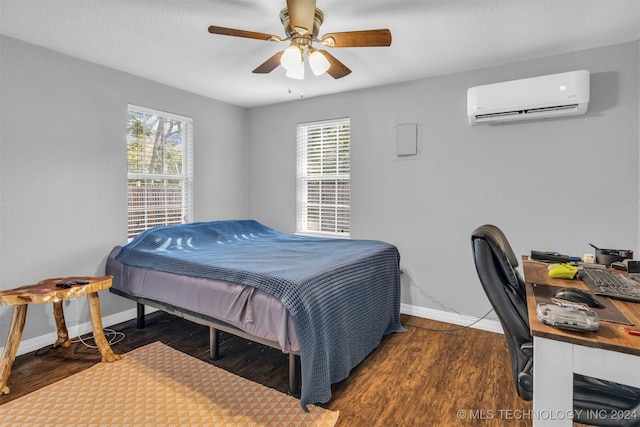 bedroom featuring ceiling fan, dark wood-type flooring, and a wall mounted air conditioner