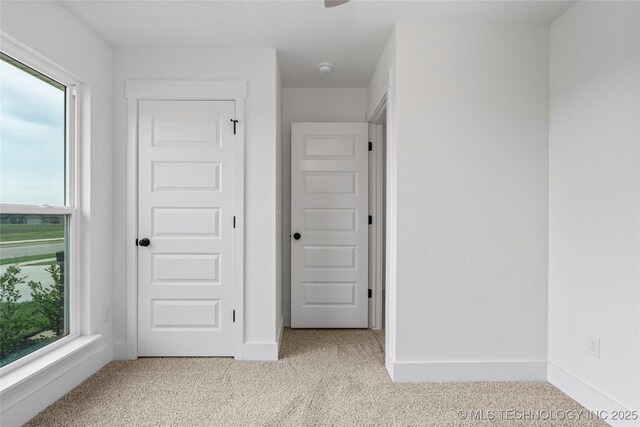 10812 S 274th Ave E, Coweta, OK 74014 - unfurnished bedroom featuring multiple windows, carpet floors, and baseboards