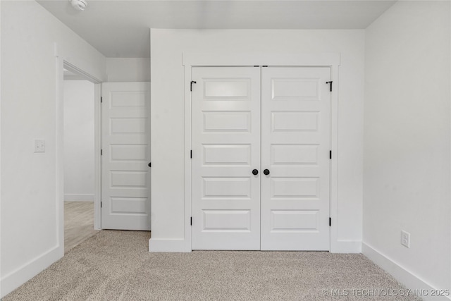 10812 S 274th Ave E, Coweta, OK 74014 - unfurnished bedroom featuring carpet flooring, a closet, and baseboards