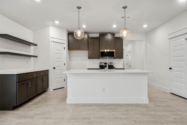 10812 S 274th Ave E, Coweta, OK 74014 - kitchen featuring stainless steel appliances, open shelves, tasteful backsplash, dark brown cabinets, and recessed lighting