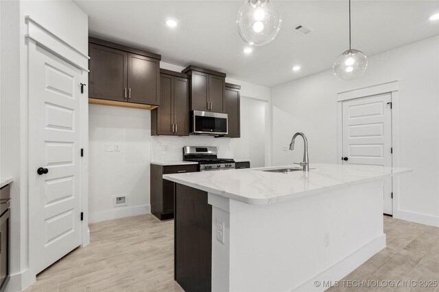 10812 S 274th Ave E, Coweta, OK 74014 - kitchen featuring appliances with stainless steel finishes, a sink, light wood-style floors, baseboards, and recessed lighting