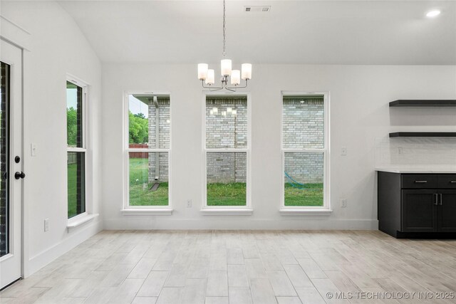 10812 S 274th Ave E, Coweta, OK 74014 - unfurnished dining area with a chandelier, light wood finished floors, baseboards, and vaulted ceiling