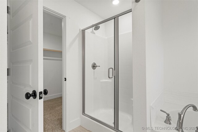 10812 S 274th Ave E, Coweta, OK 74014 - full bathroom with a stall shower, a walk in closet, and a garden tub