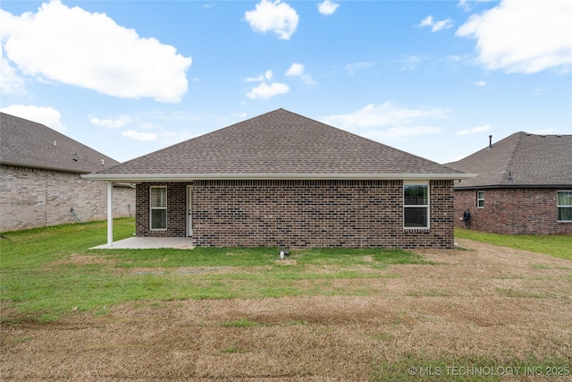 10812 S 274th Ave E, Coweta, OK 74014 - back of house with a patio area, brick siding, roof with shingles, and a lawn