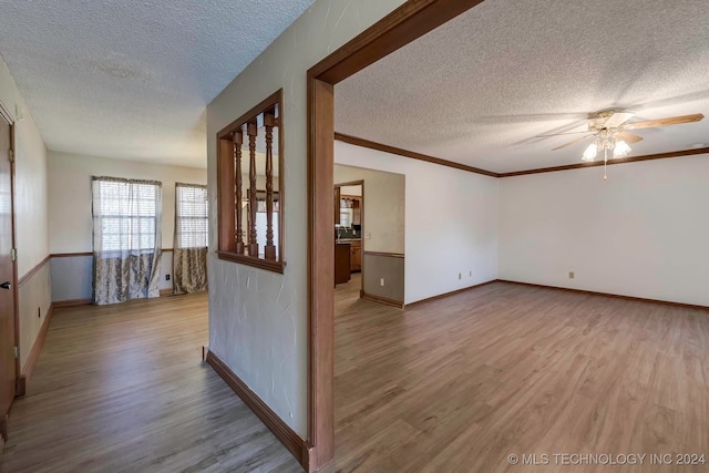 unfurnished room with ceiling fan, light hardwood / wood-style floors, and a textured ceiling