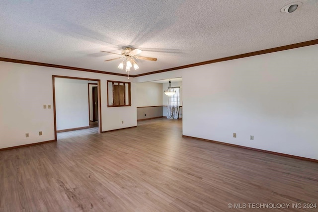 spare room featuring ornamental molding, hardwood / wood-style flooring, ceiling fan, and a textured ceiling