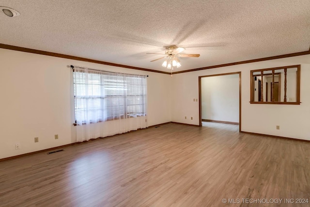 spare room with crown molding, ceiling fan, wood-type flooring, and a textured ceiling