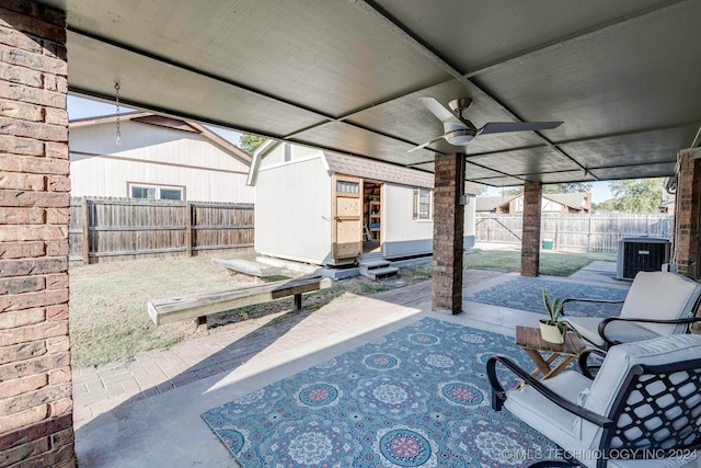 view of patio featuring ceiling fan, a shed, and central AC