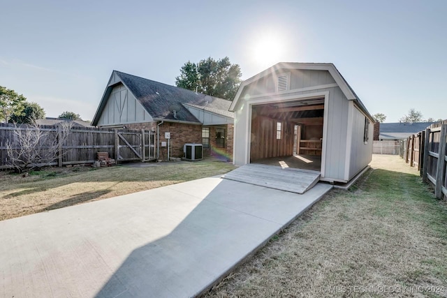 back of property with a patio, a storage shed, central AC unit, and a lawn