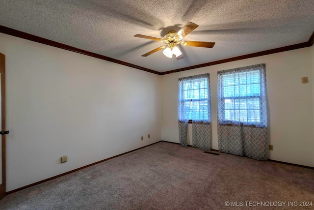 spare room with ceiling fan, carpet flooring, ornamental molding, and a textured ceiling