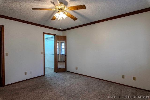 carpeted empty room with ceiling fan, a textured ceiling, and crown molding