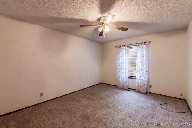 carpeted spare room with ceiling fan and a textured ceiling