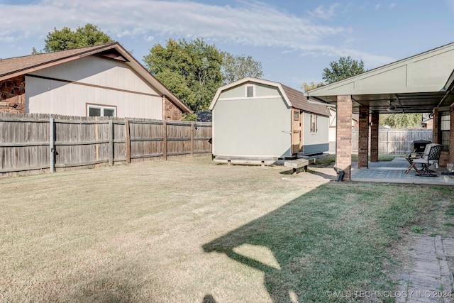 view of yard with a shed and a patio area