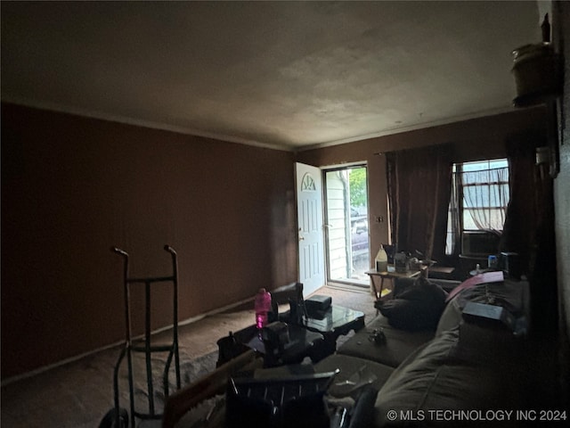 carpeted living room with ornamental molding