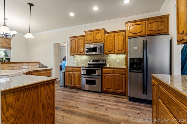 kitchen with decorative backsplash, stainless steel appliances, hardwood / wood-style flooring, ornamental molding, and decorative light fixtures