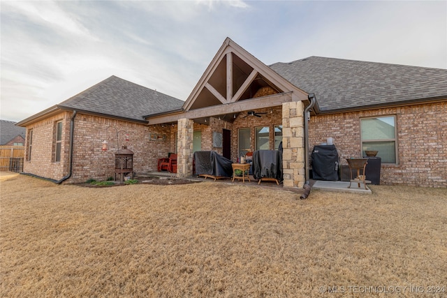 rear view of house featuring a yard, ceiling fan, and a patio