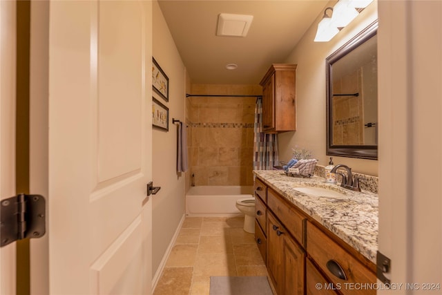 full bathroom featuring vanity, tiled shower / bath combo, and toilet