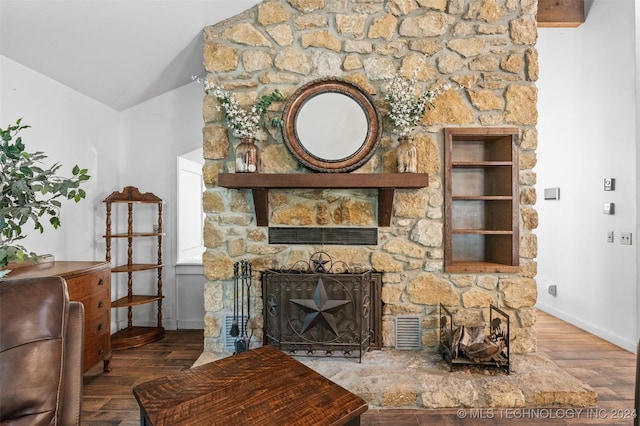 living room with a fireplace, hardwood / wood-style flooring, and lofted ceiling