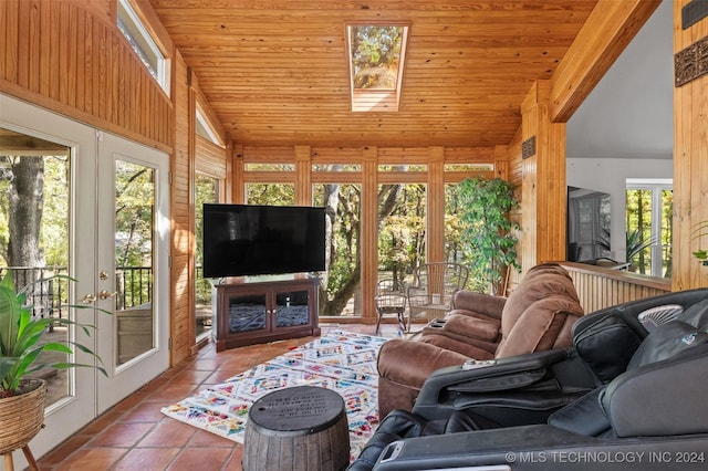 tiled living room with a healthy amount of sunlight, a skylight, wood ceiling, and french doors