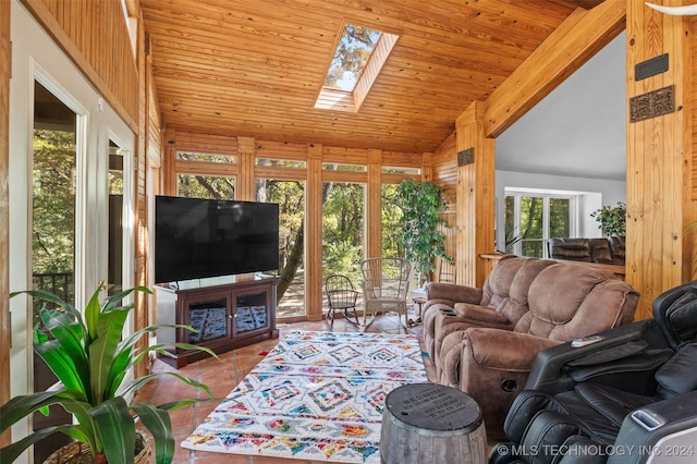 living room featuring a skylight and high vaulted ceiling