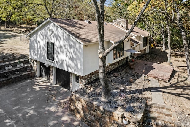 view of side of home featuring a garage