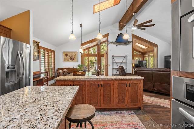 kitchen featuring stainless steel refrigerator with ice dispenser, vaulted ceiling with beams, decorative light fixtures, and a healthy amount of sunlight