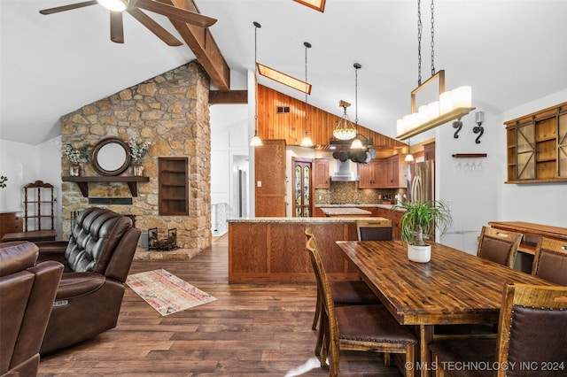 dining space featuring ceiling fan, a fireplace, high vaulted ceiling, and dark wood-type flooring