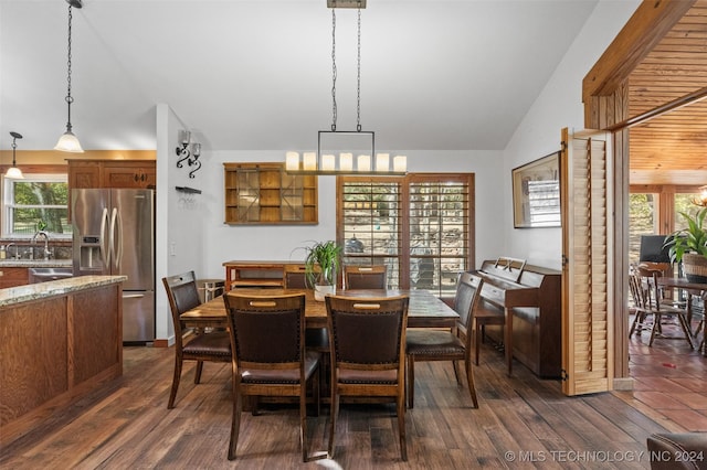 dining area featuring plenty of natural light, high vaulted ceiling, dark hardwood / wood-style floors, and sink