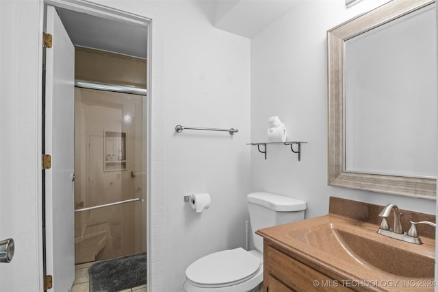 bathroom featuring vanity, toilet, and walk in shower