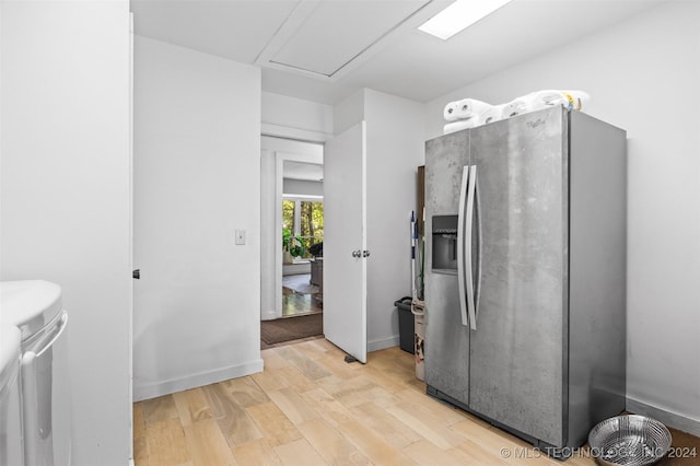 kitchen with stainless steel fridge and light hardwood / wood-style flooring