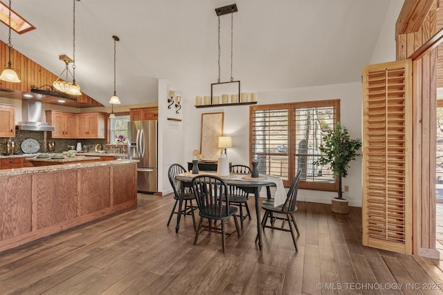 dining room with baseboards, high vaulted ceiling, and dark wood-type flooring