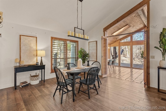 dining space with wood ceiling, lofted ceiling with beams, baseboards, and wood finished floors