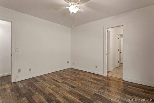 unfurnished room featuring wood finished floors, a ceiling fan, and baseboards