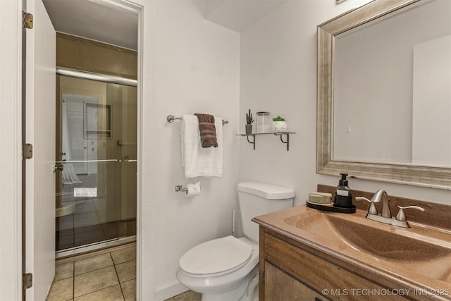 full bathroom with a stall shower, vanity, toilet, and tile patterned floors