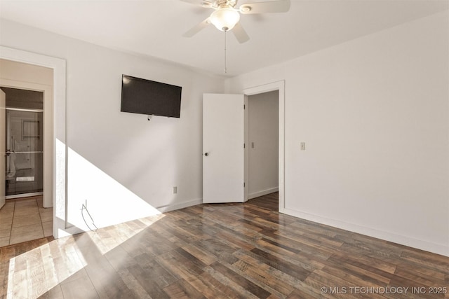 spare room with a ceiling fan, baseboards, and wood finished floors