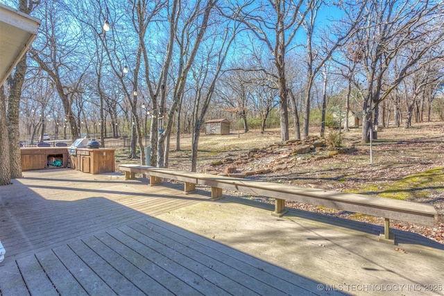 deck with an outdoor structure and a storage shed