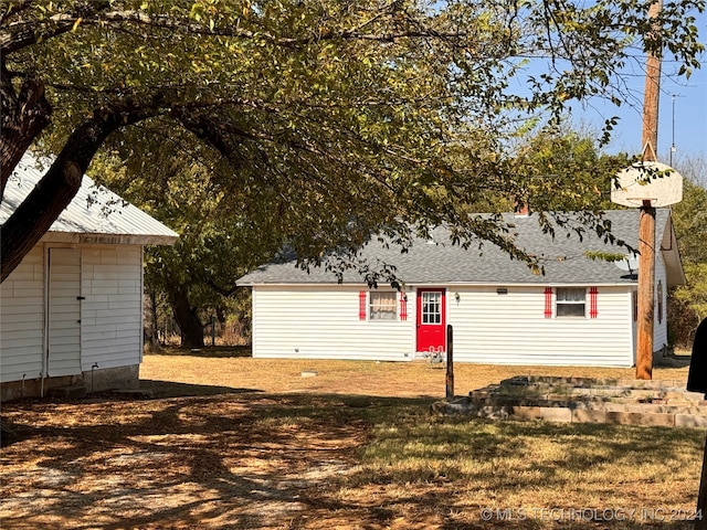 back of property with a lawn