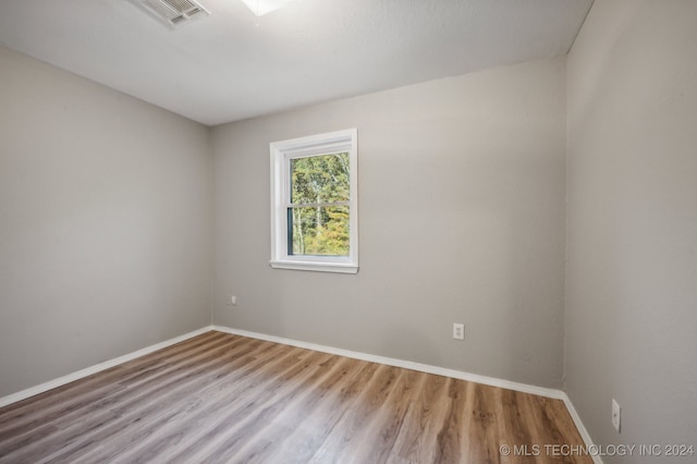 empty room with hardwood / wood-style floors