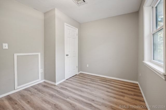 spare room featuring light hardwood / wood-style flooring